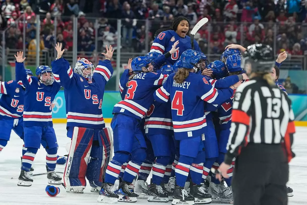 United States' players celebrate after a women's ice hockey gold medal game between the United States and Canada at the 2026 Winter Olympics, in Milan, Italy, Thursday, Feb. 19, 2026. (AP Photo/Petr David Josek)