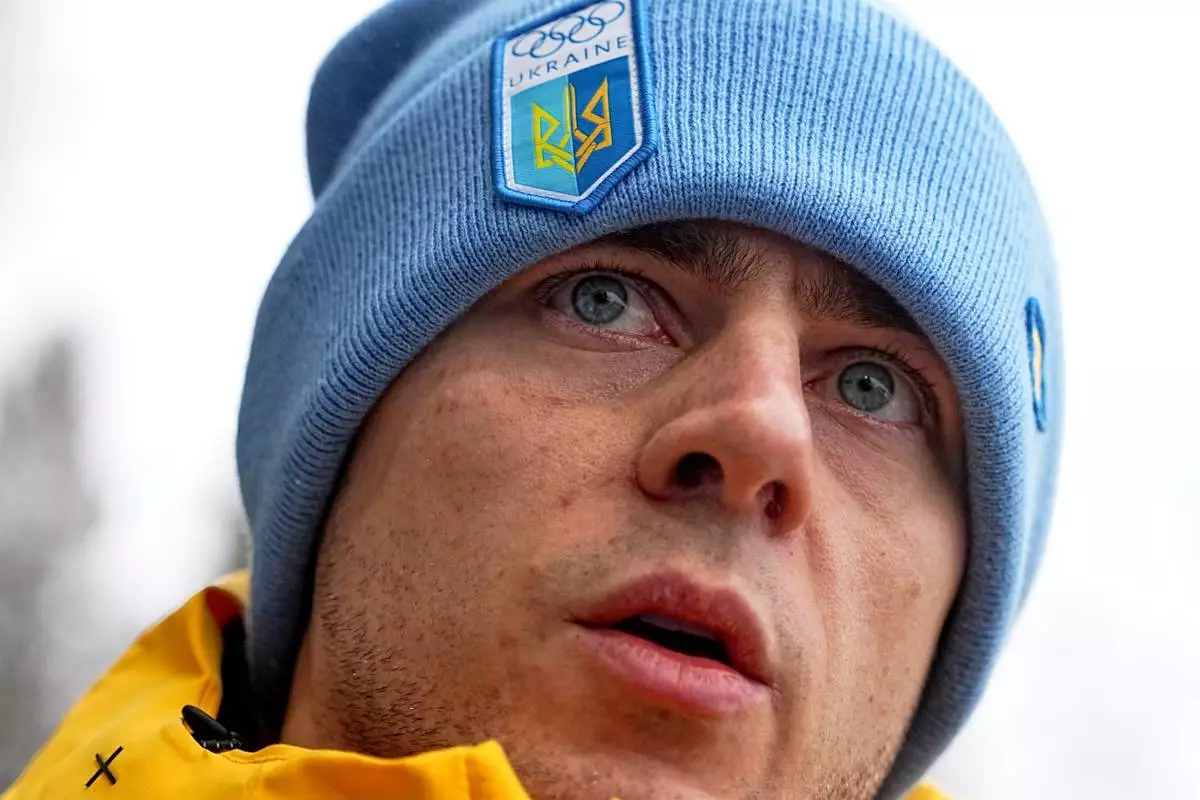 Ukrainian skeleton athlete Vladyslav Heraskevych talks to the media at the start house of the sliding center at the 2026 Winter Olympics, in Cortina d'Ampezzo, Italy, Thursday, Feb. 12, 2026. (AP Photo/Fatima Shbair)