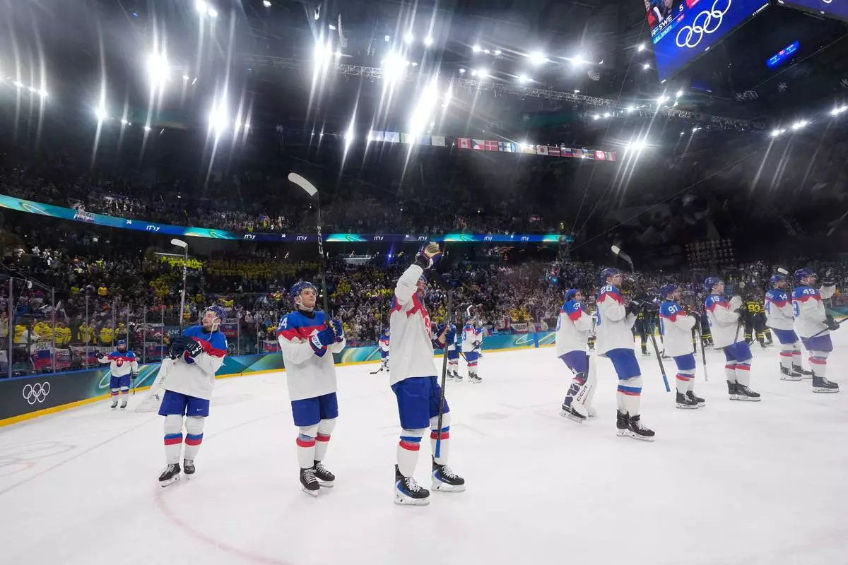 Slovakia applaud fans at the end of a preliminary round match of men's ice hockey between Sweden and Slovakia at the 2026 Winter Olympics, in Milan, Italy, Saturday, Feb. 14, 2026. (AP Photo/Petr David Josek)