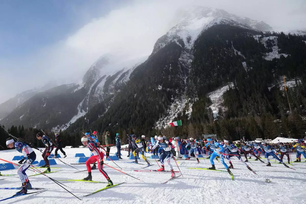 Lukas Hofer, of Italy, center right, competes in the men's 15-kilometer mass start biathlon race at the 2026 Winter Olympics in Anterselva, Italy, Friday, Feb. 20, 2026. (AP Photo/Andrew Medichini)