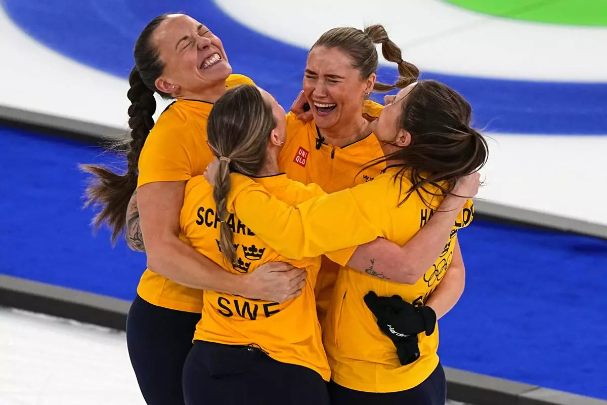 Sweden's Anna Hasselborg, Sara McManus, Sofia Scharback, Agnes Knochenhauer celebrate winning a women's curling semifinal match against Canada at the 2026 Winter Olympics, in Cortina d'Ampezzo, Italy, Friday, Feb. 20, 2026. (AP Photo/Fatima Shbair)