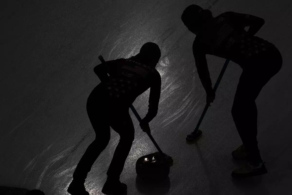 Taylor Anderson-Heide of the United States, right, and Cory Thiesse of the United States compete against Switzerland during the curling women's semifinal match at the 2026 Winter Olympics, in Cortina d'Ampezzo, Italy, Friday, Feb. 20, 2026. (AP Photo/Christophe Ena)