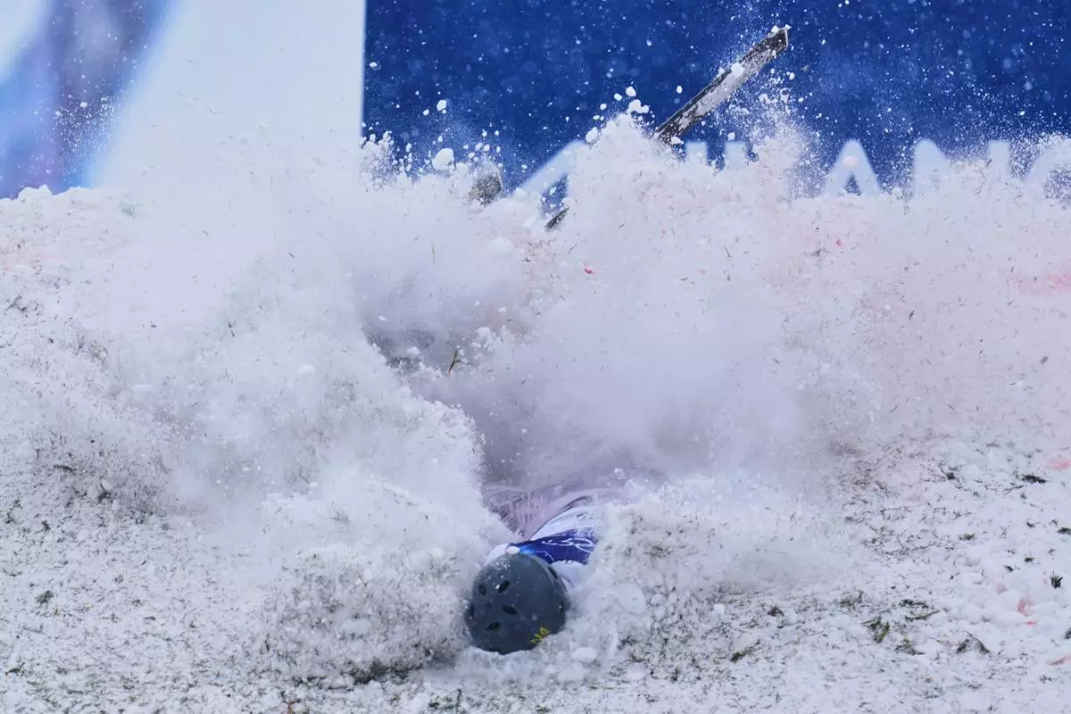 Ukraine's Maksym Kuznietsov crashes during the men's freestyle skiing aerials qualifications at the 2026 Winter Olympics, in Livigno, Italy, Friday, Feb. 20, 2026. (AP Photo/Abbie Parr)