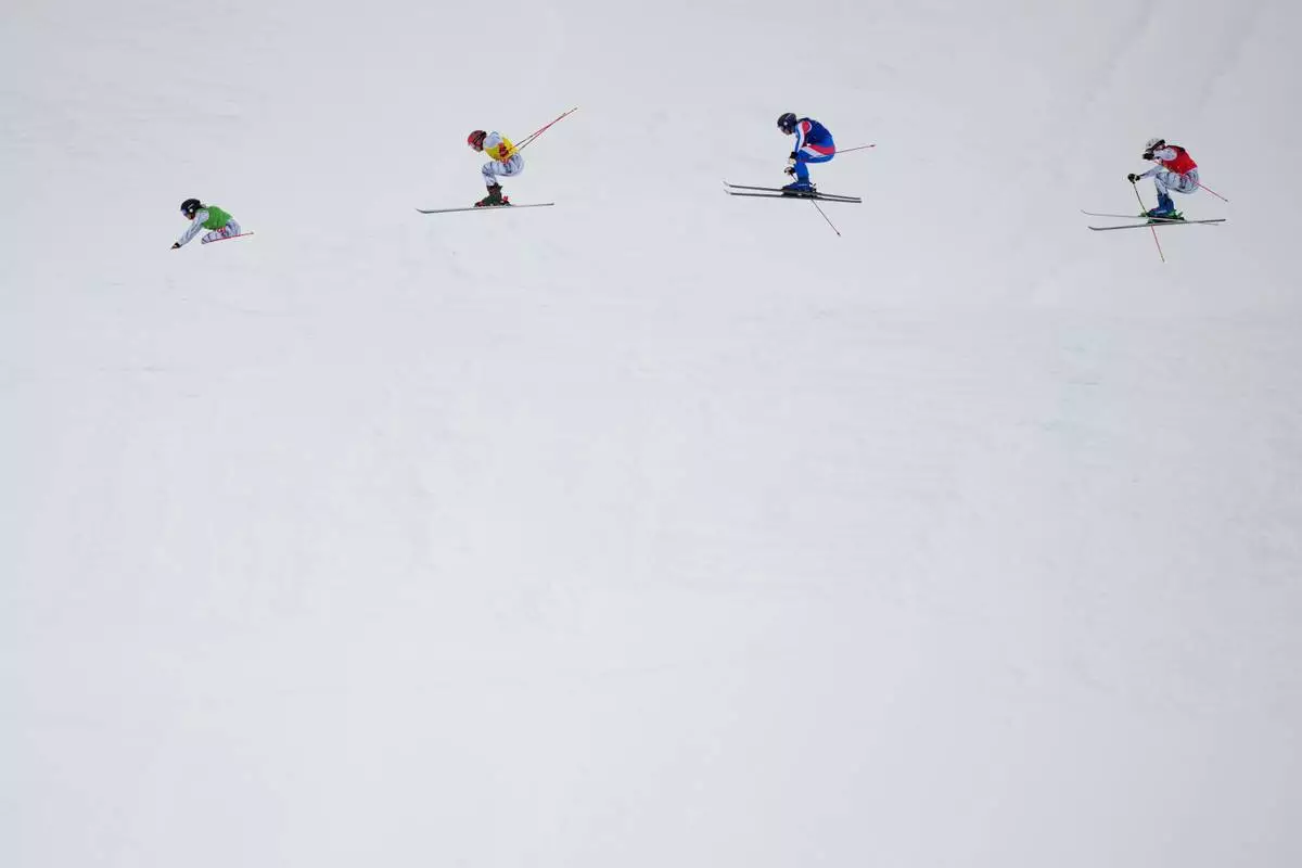 From left, Switzerland's Talina Gantenbein (5), Switzerland's Sixtine Cousin (13), France's Anouck Errard (12) and Switzerland's Saskja Lack (4) compete during the women's ski cross finals at the 2026 Winter Olympics, in Livigno, Italy, Friday, Feb. 20, 2026. (AP Photo/Julia Demaree Nikhinson)