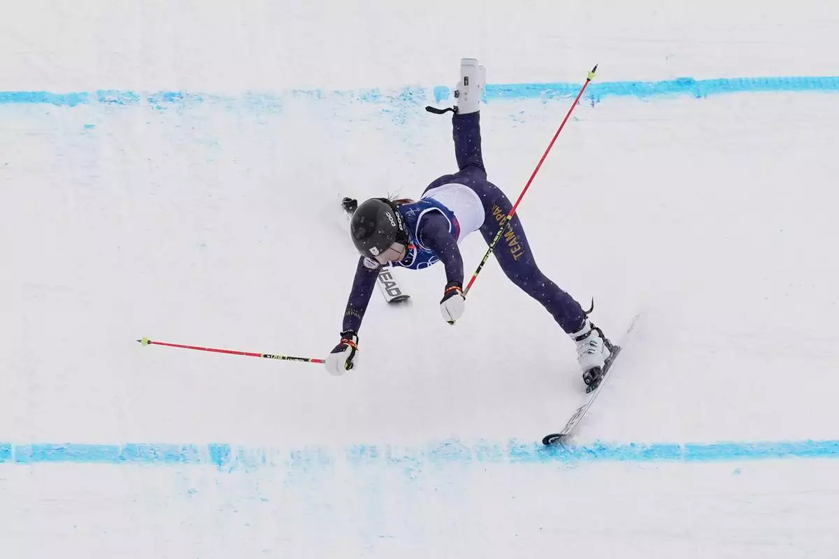 Japan's Makiko Arai (27) crashes during the women's ski cross qualifications at the 2026 Winter Olympics, in Livigno, Italy, Friday, Feb. 20, 2026. (AP Photo/Rebecca Blackwell)
