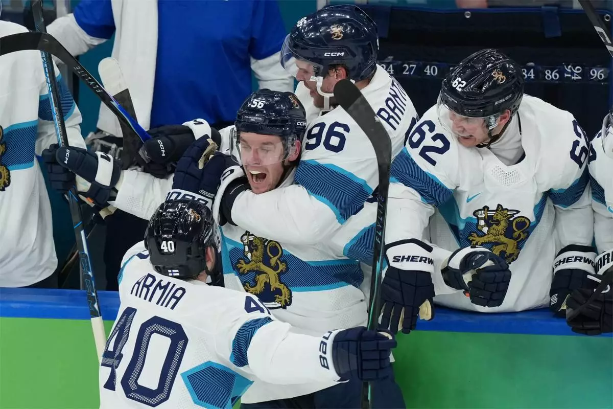 Finland's Erik Haula (56) celebrates after scoring a goal against Canada during the second period of a men's ice hockey semifinal game at the 2026 Winter Olympics in Milan, Italy, Friday, Feb. 20, 2026. (AP Photo/Carolyn Kaster)