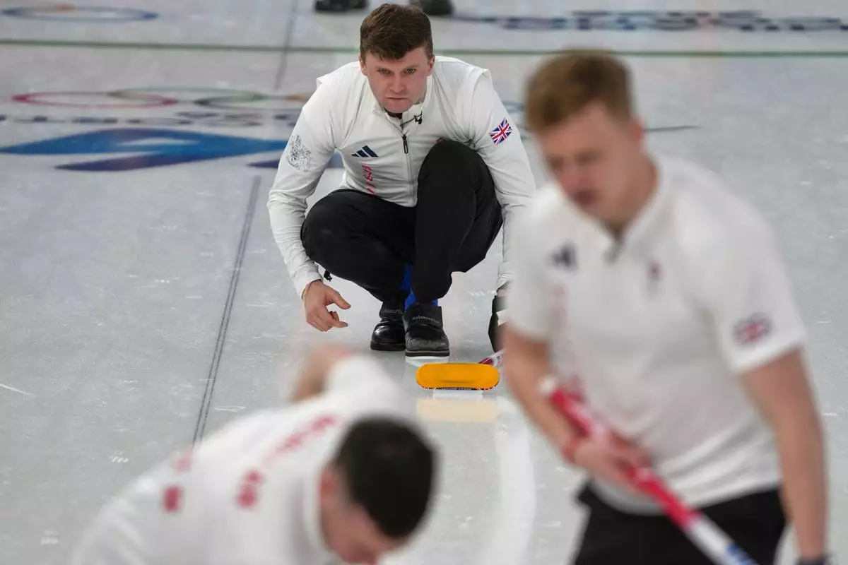 Britain's Bruce Mouat in action during the men's curling round robin session against the United States, at the 2026 Winter Olympics, in Cortina d'Ampezzo, Italy, Wednesday, Feb. 18, 2026. (AP Photo/Misper Apawu)