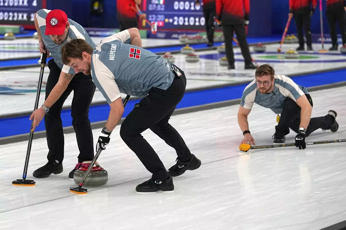 Norway's Martin Sesaker, Bendik Ramsfjell and Gaute Nepstad in action during the men's curling round robin session against Canada at the 2026 Winter Olympics, in Cortina d'Ampezzo, Italy, Thursday, Feb. 19, 2026. (AP Photo/Fatima Shbair)