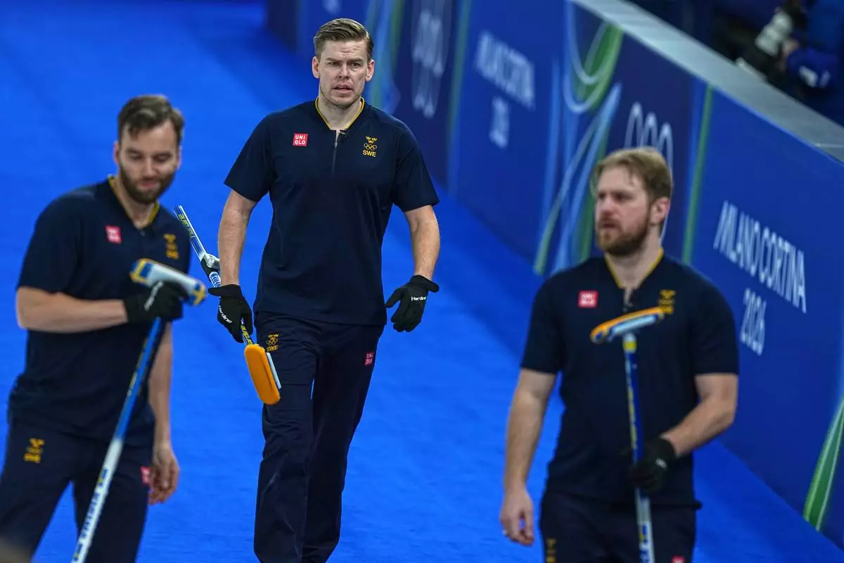 Sweden's Rasmus Wranaa, Oskar Eriksson and Christoffer Sundgren compete during the men's curling round robin session against Czechia at the 2026 Winter Olympics, in Cortina d'Ampezzo, Italy, Thursday, Feb. 19, 2026. (AP Photo/Fatima Shbair)