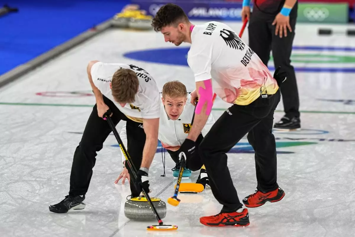 Germany's Benjamin Kapp, Felix Messenzehl and Johannes Scheuerl in action during the men's curling round robin session against China at the 2026 Winter Olympics, in Cortina d'Ampezzo, Italy, Thursday, Feb. 19, 2026. (AP Photo/Fatima Shbair)
