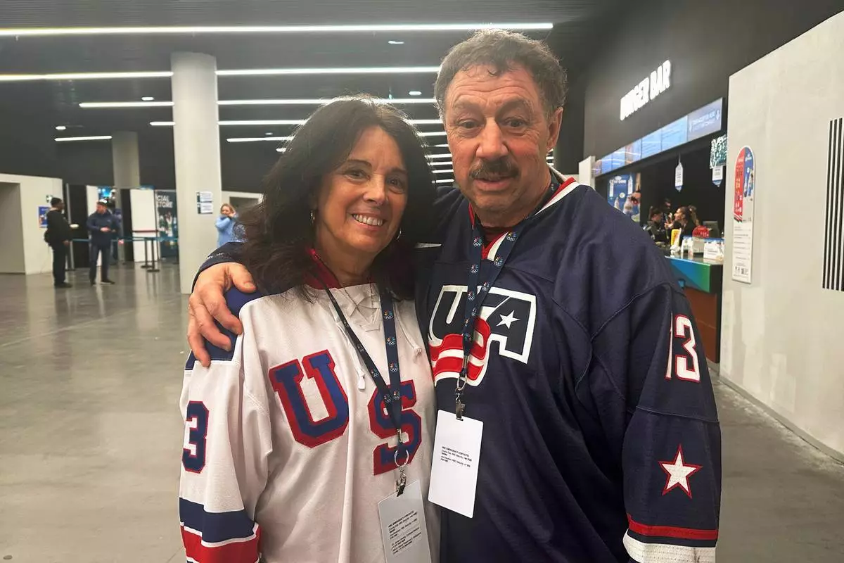 Jane and Guy Gaudreau, parents of the late Matthew and John Gaudreau, attend the men's ice hockey semifinal game against Slovakia, during the 2026 Winter Olympics, in Milan, Italy, Friday, Feb. 20, 2026. (AP Photo/Stephen Whyno)