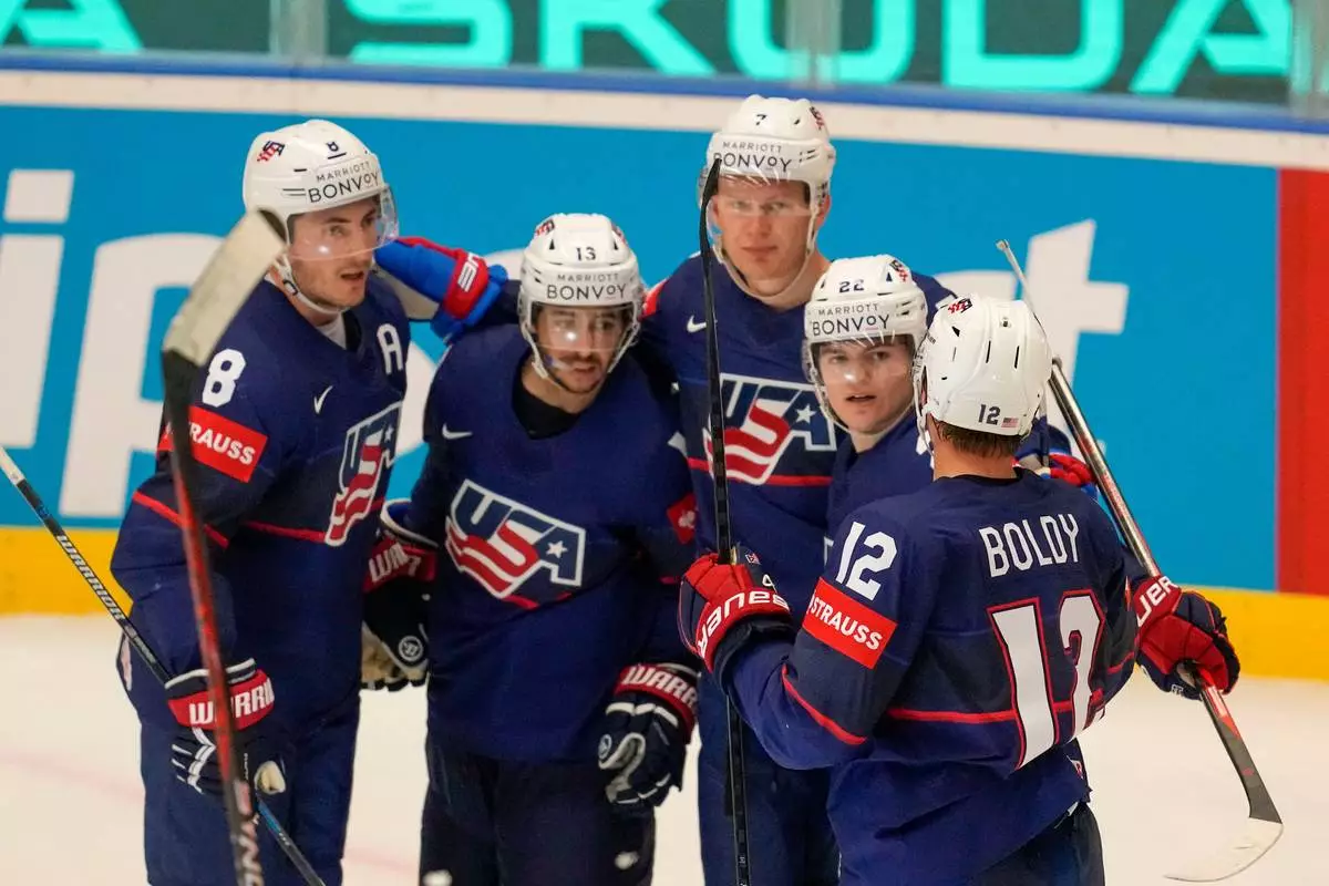 FILE - United States' Johnny Gaudreau celebrates with teammates after scoring his side's third goal during the preliminary round match between United States and Germany at the Ice Hockey World Championships in Ostrava, Czech Republic, Saturday, May 11, 2024. (AP Photo/Darko Vojinovic, File)