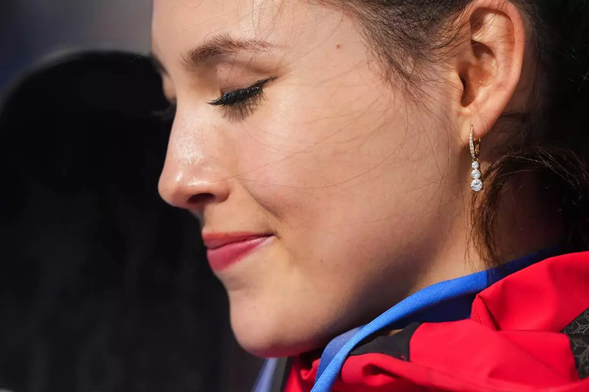 Gold medalist China's Eileen Gu reacts after winning the women's freestyle skiing halfpipe final at the 2026 Winter Olympics, in Livigno, Italy, Sunday, Feb. 22, 2026. (AP Photo/Lindsey Wasson)