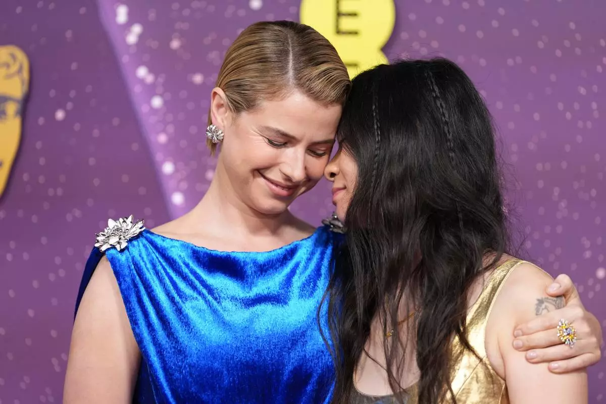 Jessie Buckley, left, and Chloe Zhao pose for photographers upon arrival at the 79th British Academy Film Awards, BAFTA's, in London, Sunday, Feb. 22, 2026. (AP Photo/Alastair Grant)