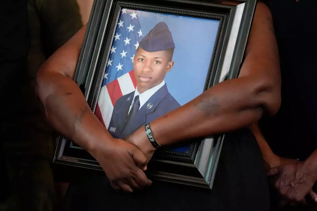 FILE - Chantemekki Fortson, mother of slain U.S. Air Force senior airman Roger Fortson, holds a photo of her son during a news conference with attorney Ben Crump on June 3, 2024, in Atlanta. (AP Photo/Brynn Anderson, File)