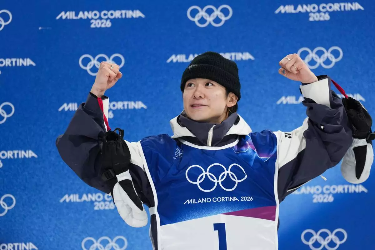 Japan's Yuto Totsuka celebrates winning the gold medal in the men's snowboarding halfpipe finals at the 2026 Winter Olympics, in Livigno, Italy, Friday, Feb. 13, 2026. (AP Photo/Abbie Parr)