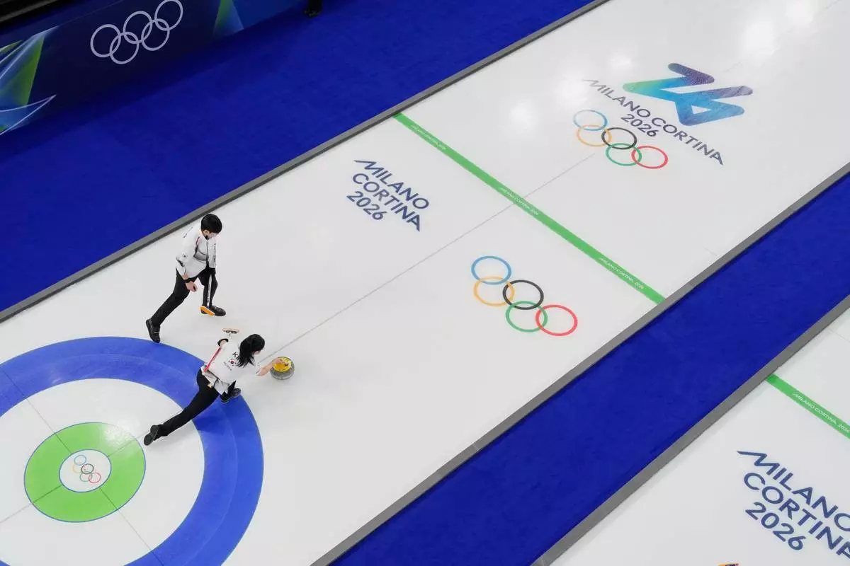 South Korea's Jeong Yeong-seok and Kim Seon-yeong compete during a curling mixed doubles session at the 2026 Winter Olympics in Cortina d'Ampezzo, Italy, Wednesday, Feb. 4, 2026. (AP Photo/David J. Phillip)