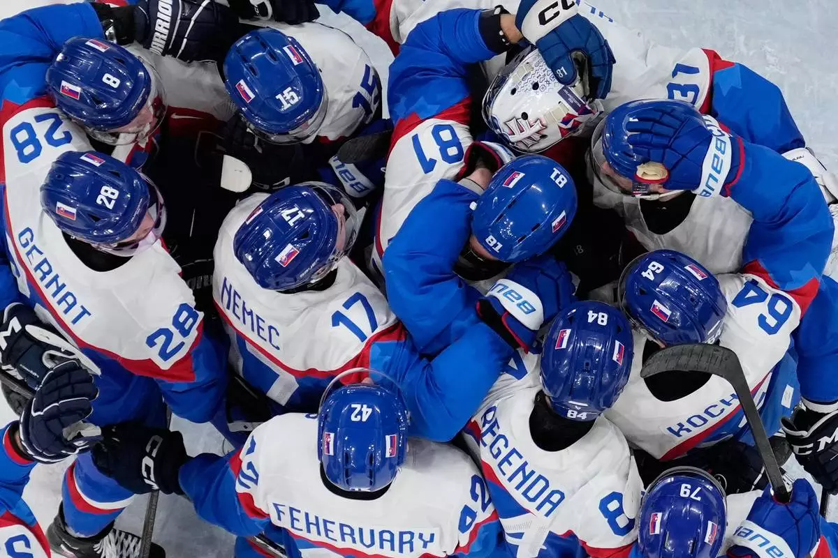 Slovakia players celebrate there victory after a men's ice hockey quarterfinal game between Slovakia and Germany at the 2026 Winter Olympics, in Milan, Italy, Wednesday, Feb. 18, 2026. (AP Photo/Petr David Josek)