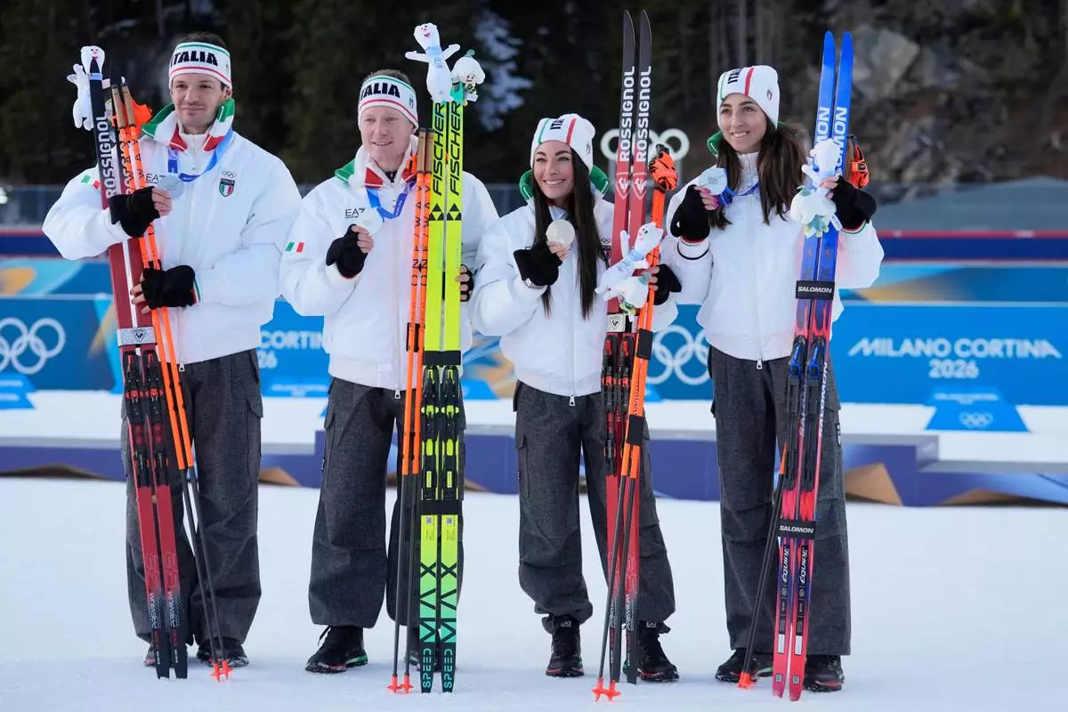 Italy's Lisa Vittozzi, Dorothea Wierer, Lukas Hofer and Tommaso Giacomel pose with the silver medal for the 4X6-kilometer mixed relay biathlon race at the 2026 Winter Olympics in Anterselva, Italy, Sunday, Feb. 8, 2026. (AP Photo/Andrew Medichini)
