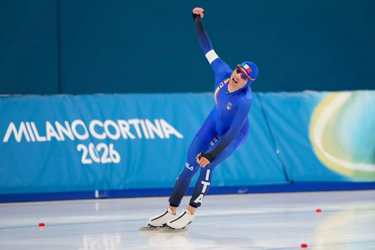 Riccardo Lorello of Italy celebrates after competing in the men's 5,000 meters speedskating race at the 2026 Winter Olympics, in Milan, Italy, Sunday, Feb. 8, 2026. (AP Photo/Ben Curtis)