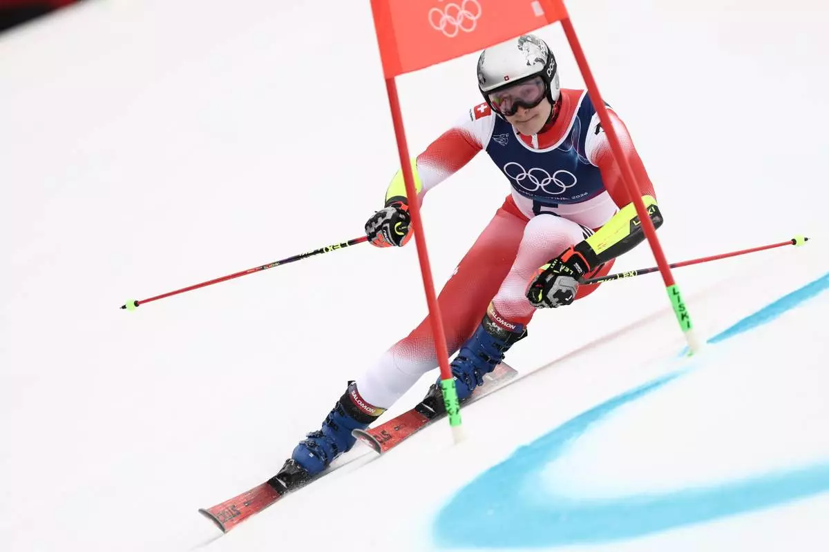 Switzerland's Marco Odermatt speeds down the course, during an alpine ski, men's giant slalom race, at the 2026 Winter Olympics, in Bormio, Italy, Saturday, Feb. 14, 2026. (AP Photo/Gabriele Facciotti)