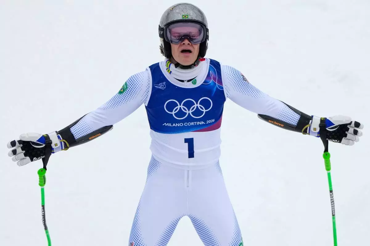 Brazil's Lucas Pinheiro Braathen celebrates winning an alpine ski, men's giant slalom race, at the 2026 Winter Olympics, in Bormio, Italy, Saturday, Feb. 14, 2026. (AP Photo/John Locher)