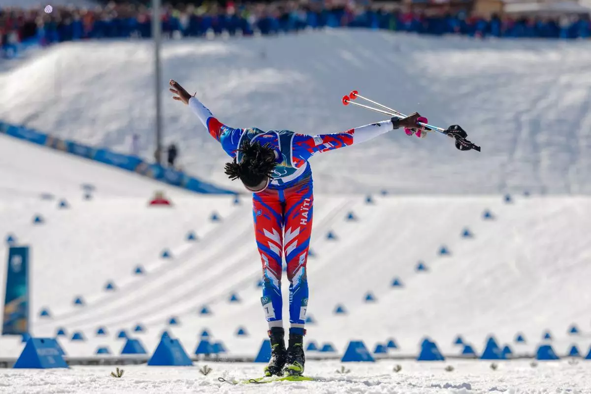 Stevenson Savart, of Haiti, bows as he crosses the finish line in the cross country skiing men's 10km + 10km skiathlon at the 2026 Winter Olympics, in Tesero, Italy, Sunday, Feb. 8, 2026. (AP Photo/Kirsty Wigglesworth)