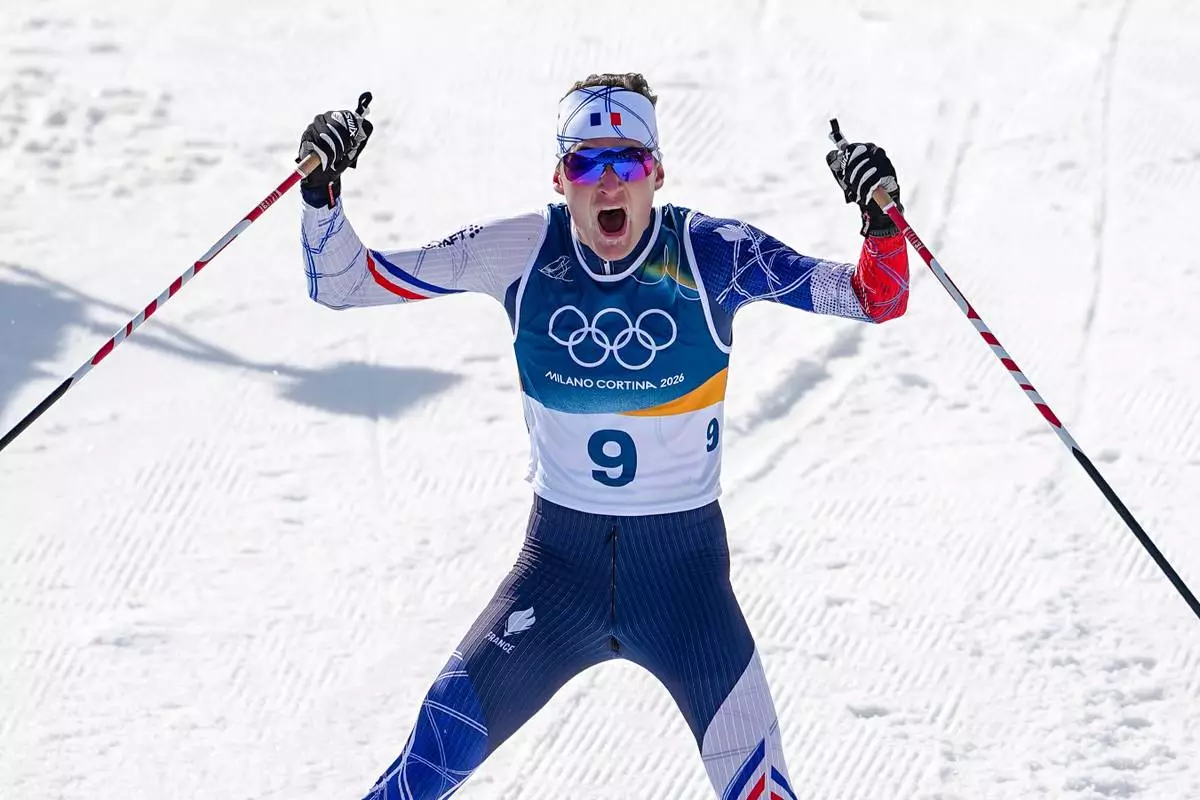 Mathis Desloges, of France, celebrates after winning the silver medal in the cross country skiing men's 10km + 10km skiathlon at the 2026 Winter Olympics, in Tesero, Italy, Sunday, Feb. 8, 2026. (AP Photo/Matthias Schrader)