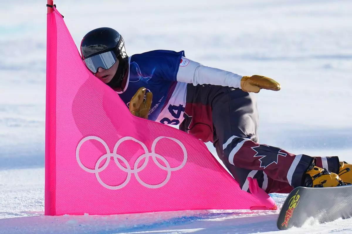 Canada's Arnaud Gaudet competes against Bulgaria's Tervel Zamfirov during the men's snowboarding parallel giant slalom qualifications at the 2026 Winter Olympics, in Livigno, Italy, Sunday, Feb. 8, 2026. (AP Photo/Gregory Bull)