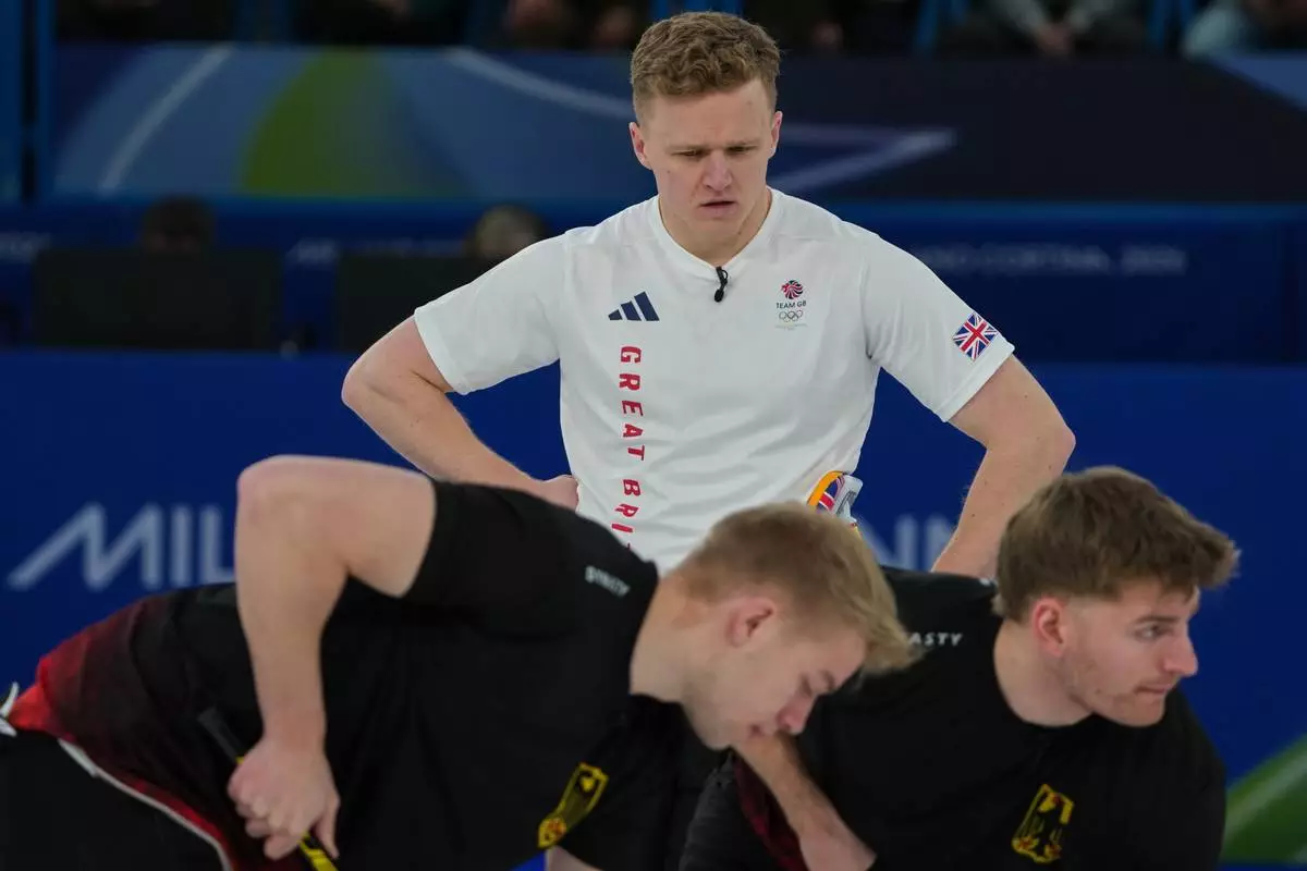 Britain's Bobby Lammie in action during the men's curling round robin session against Germany, at the 2026 Winter Olympics, in Cortina d'Ampezzo, Italy, Sunday, Feb. 15, 2026. (AP Photo/Misper Apawu)