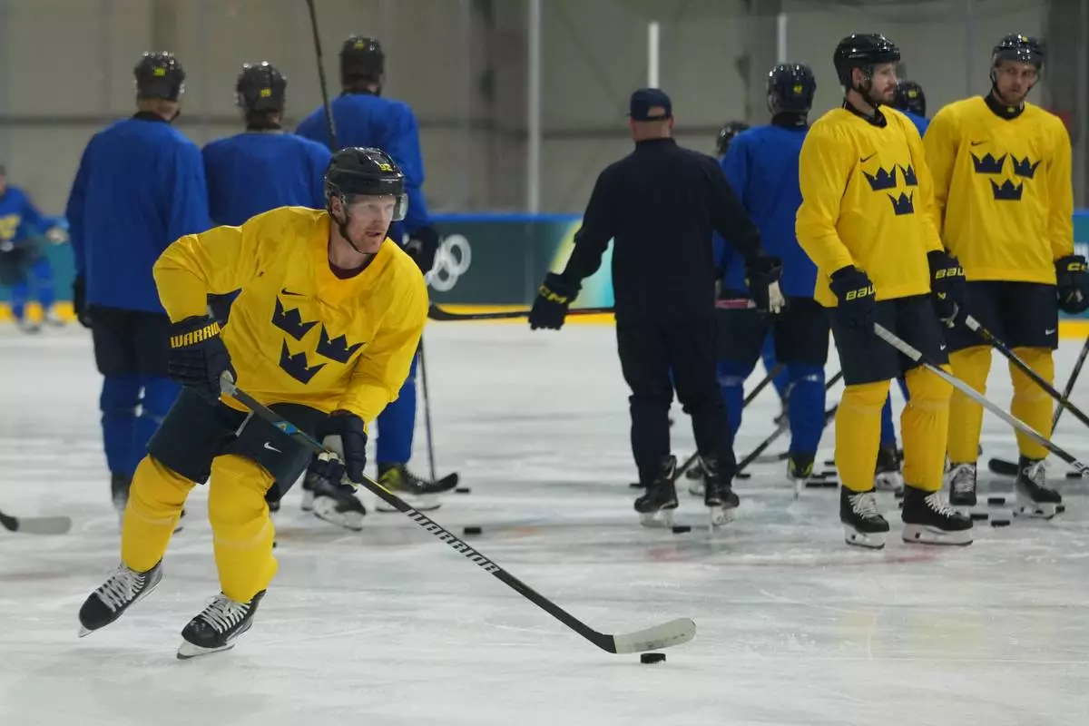 Sweden's Gabriel Landeskog skates with the puck during men's ice hockey practice at the 2026 Winter Olympics, in Milan, Italy, Sunday, Feb. 8, 2026. (AP Photo/Carolyn Kaster)