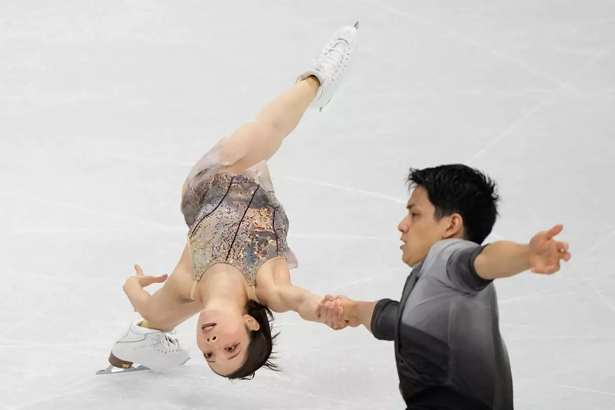 Riku Miura and Ryuichi Kihara of Japan compete during the pairs figure skating long program at the 2026 Winter Olympics, in Milan, Italy, Monday, Feb. 16, 2026. (AP Photo/Natacha Pisarenko)
