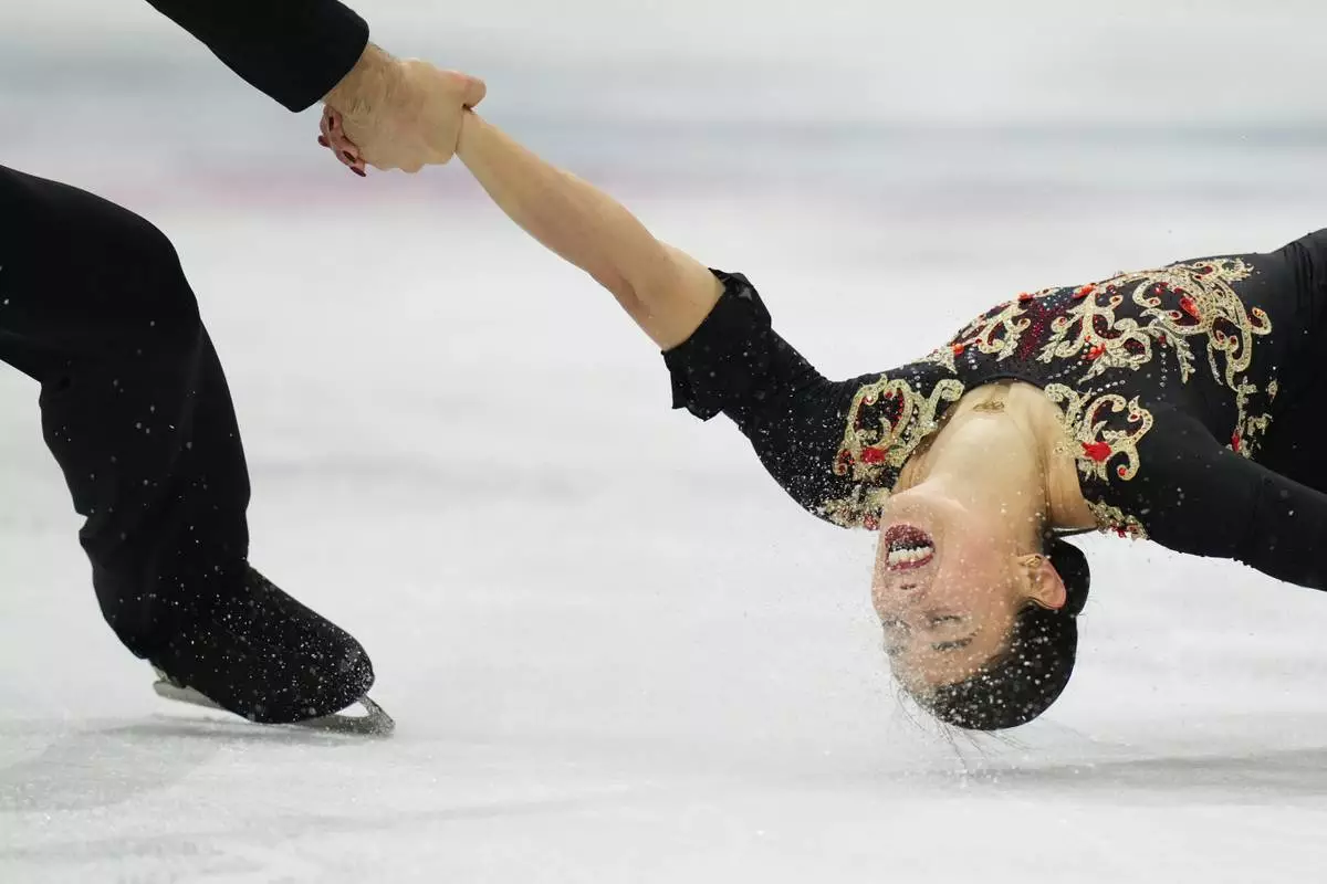 Rebecca Ghilardi and Filippo Ambrosini of Italy compete during the pairs figure skating long program at the 2026 Winter Olympics, in Milan, Italy, Monday, Feb. 16, 2026. (AP Photo/Francisco Seco)