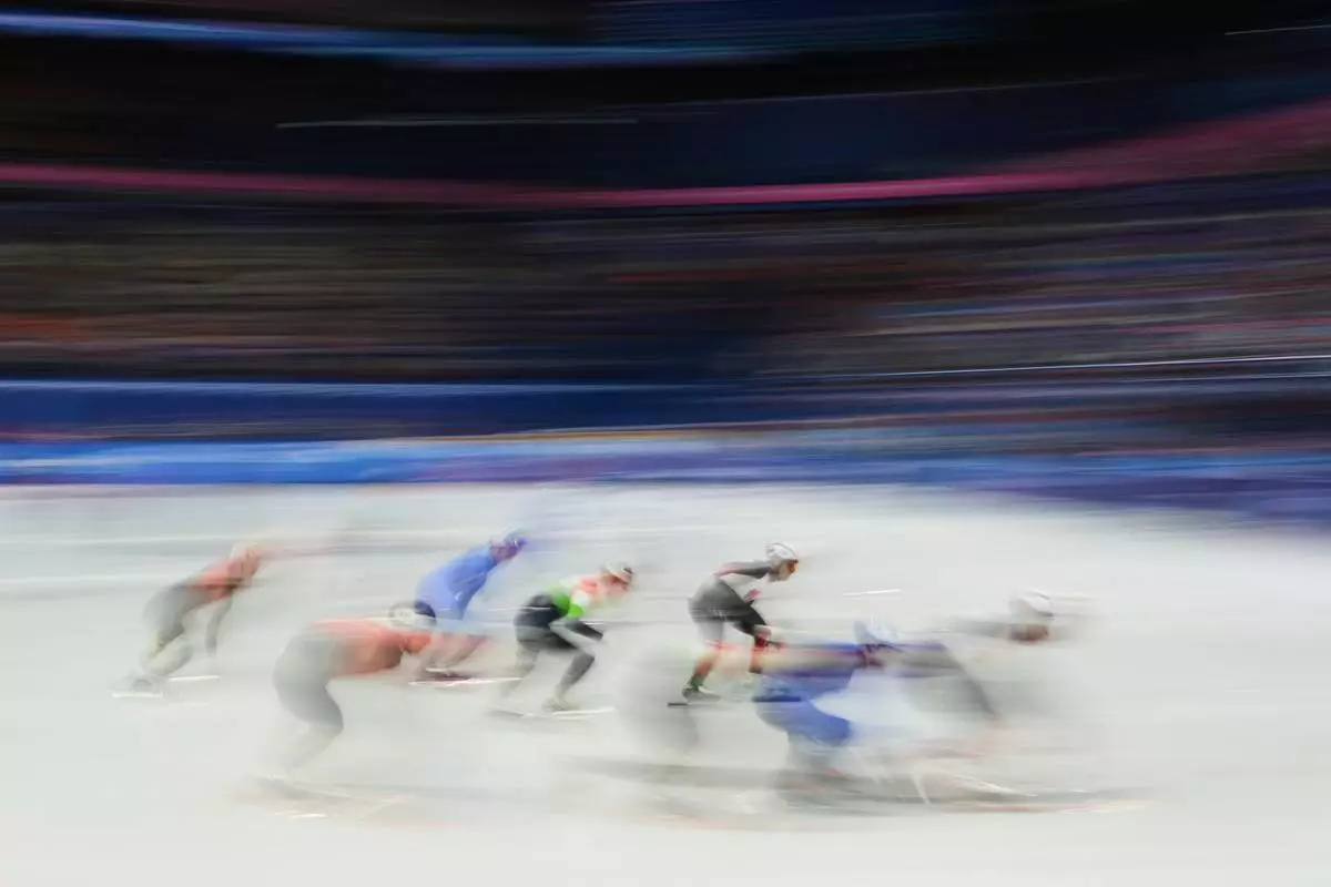 Team China, Team Italy, Team Canada and Team Hungary compete in the men's 5000m relay short track speed skating at the 2026 Winter Olympics, in Milan, Italy, Monday, Feb. 16, 2026. (AP Photo/Francisco Seco)