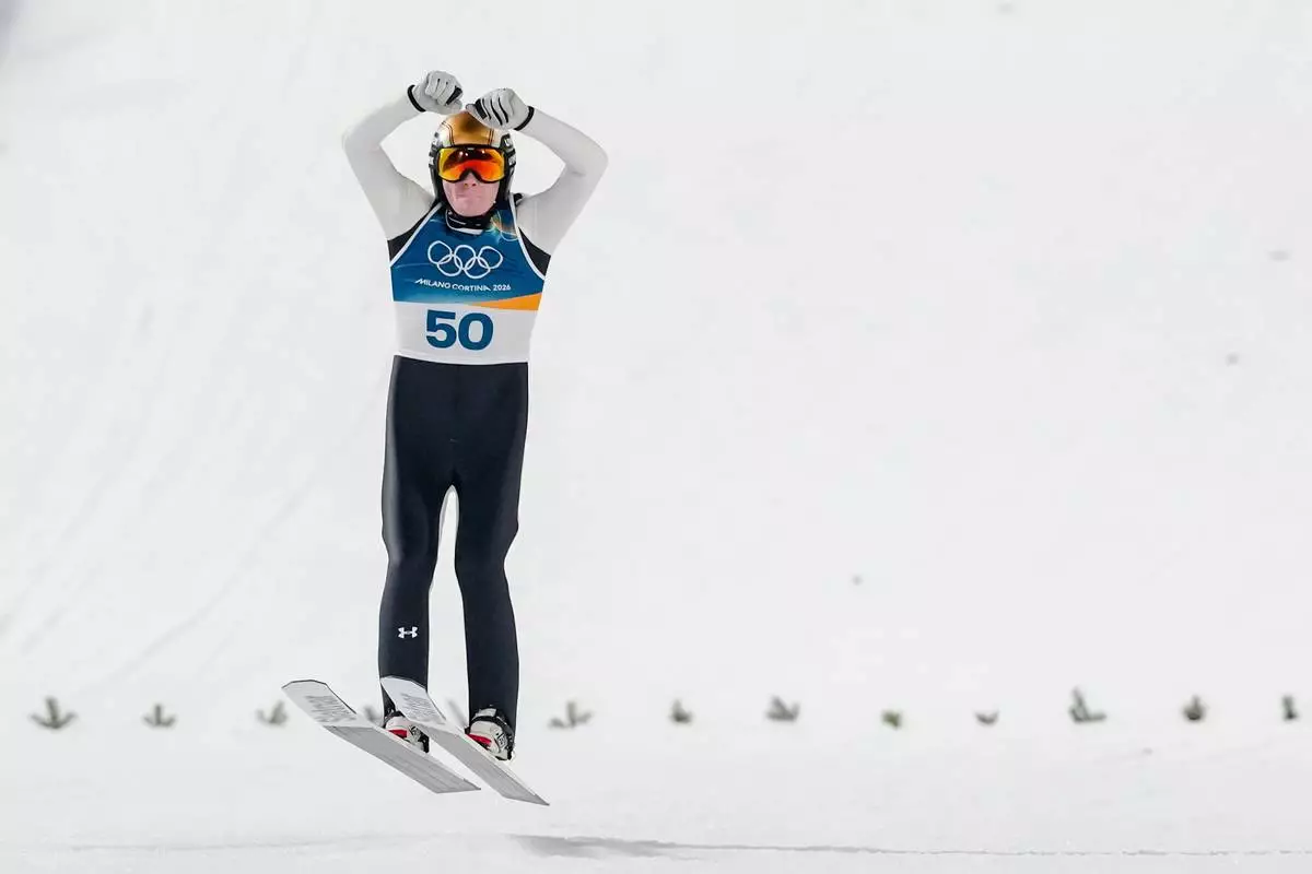 Domen Prevc, of Slovenia, celebrates after his final round jump during the ski jumping men's large hill individual at the 2026 Winter Olympics, in Predazzo, Italy, Saturday, Feb. 14, 2026. (AP Photo/Kirsty Wigglesworth)