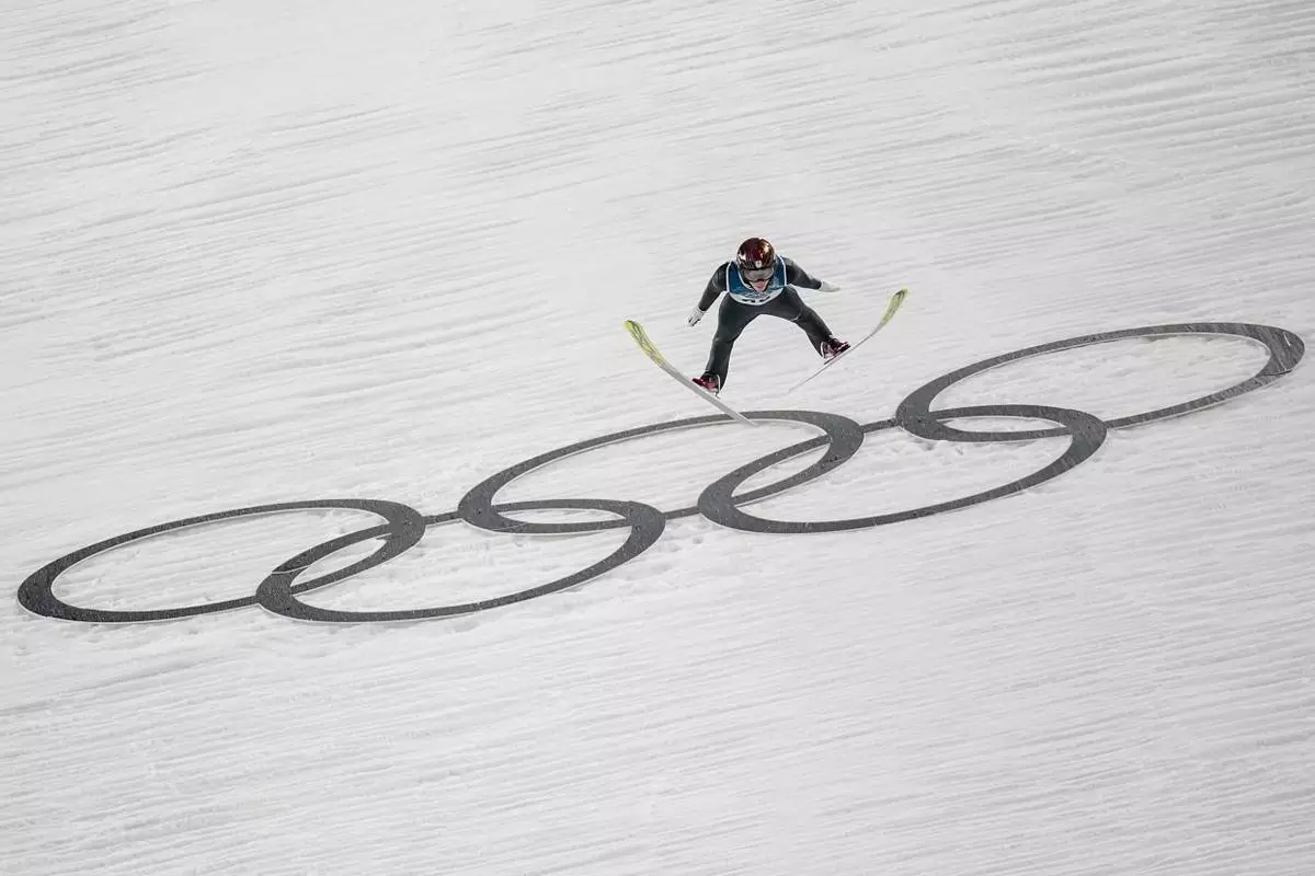 Ren Nikaido, of Japan, soars through the air during his first round jump of the ski jumping men's large hill individual at the 2026 Winter Olympics, in Predazzo, Italy, Saturday, Feb. 14, 2026. (AP Photo/Matthias Schrader)