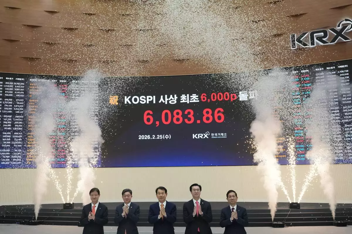 Chairman of the Financial Services Commission, Lee Eog-weon, second from left, Chairman &amp; CEO of the Korea Exchange, Jeong Eun Bo, center, a and other officials celebrate as a screen shows the Korea Composite Stock Price Index (KOSPI) of over 6,000 points during a ceremony at the Korea Exchange in Seoul, South Korea, Wednesday, Feb. 25, 2026. (AP Photo/Lee Jin-man)