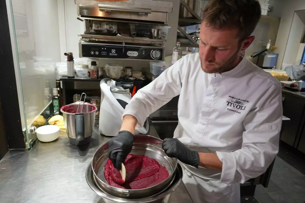 Local chef Gianluca Belli demonstrates how to make Casunziei, a type of ravioli that is Cortina's signature dish, during a pasta-making tutorial at a Michelin one-star restaurant in Cortina D'Ampezzo, Friday, Nov. 21, 2025. (AP Photo/Andrew Medichini)