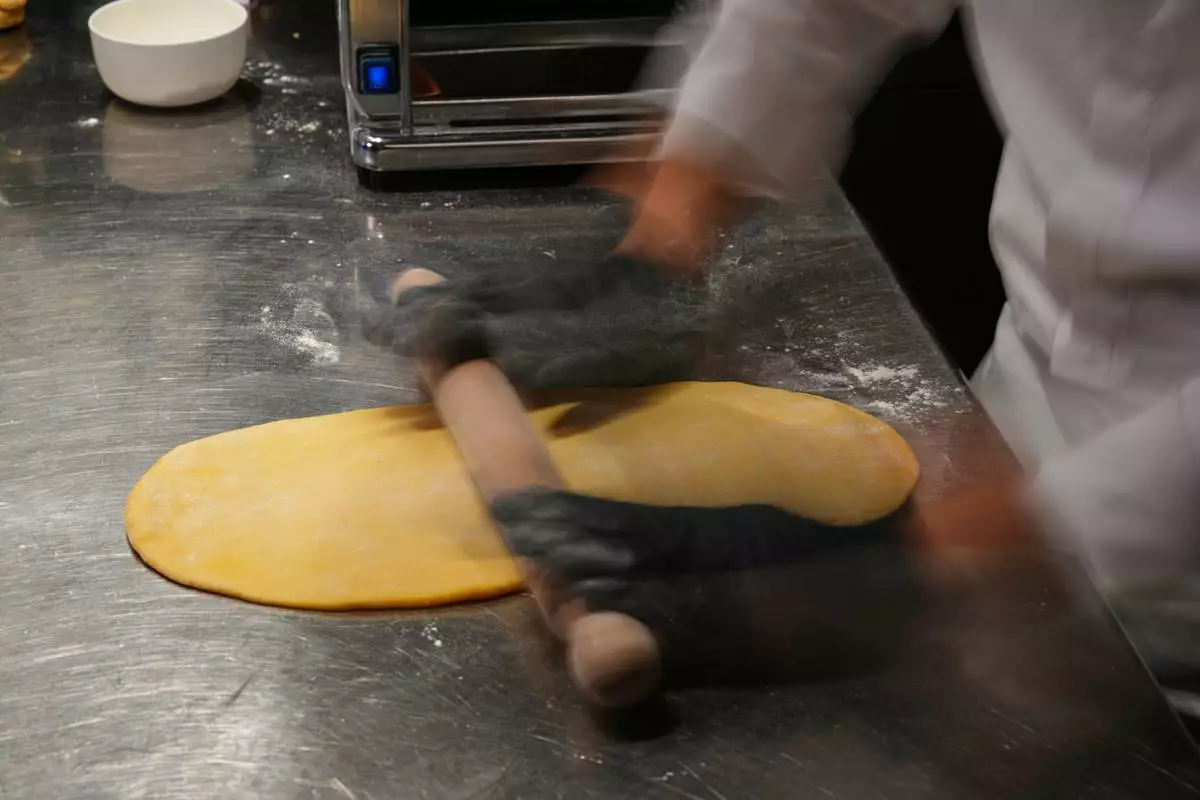 Local chef Gianluca Belli demonstrates how to make Casunziei, a type of ravioli that is Cortina's signature dish, during a pasta-making tutorial at a Michelin one-star restaurant in Cortina D'Ampezzo, Friday, Nov. 21, 2025. (AP Photo/Andrew Medichini)