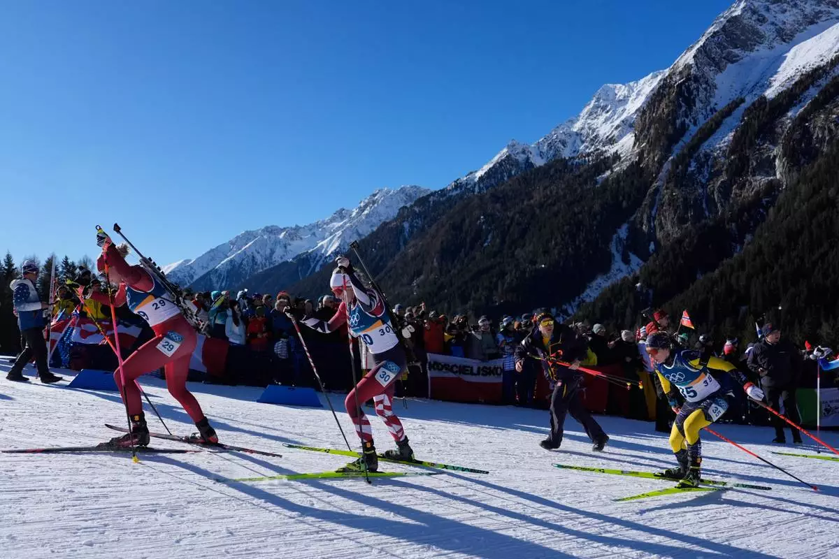Amy Baserga, of Switzerland, from left, Lisa Theresa Hauser, of Austria, and Anna Magnusson, of Sweden, compete during the women's 10-kilometer pursuit biathlon race at the 2026 Winter Olympics in Anterselva, Italy, Sunday, Feb. 15, 2026. (AP Photo/Mosa'ab Elshamy)