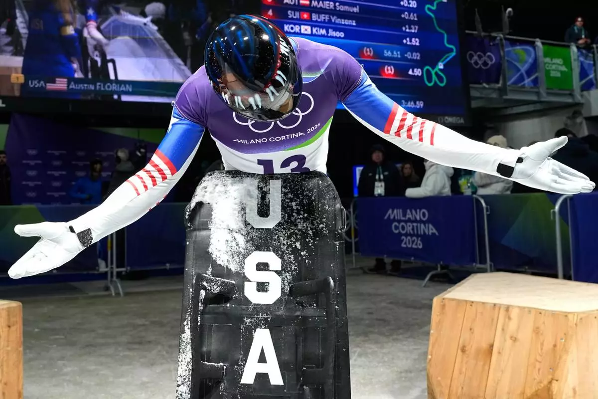 United States' Austin Florian arrives at the finish during a men's skeleton run at the 2026 Winter Olympics, in Cortina d'Ampezzo, Italy, Friday, Feb. 13, 2026. (AP Photo/Alessandra Tarantino)