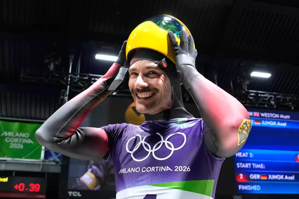 Germany's Axel Jungk arrives at the finish during a men's skeleton run at the 2026 Winter Olympics, in Cortina d'Ampezzo, Italy, Friday, Feb. 13, 2026. (AP Photo/Alessandra Tarantino)