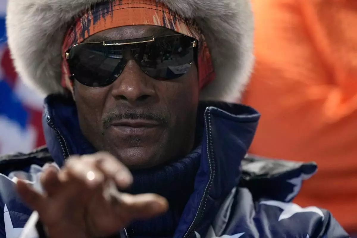Snoop Dogg watches the men's 1,000 meters speedskating race at the 2026 Winter Olympics, in Milan, Italy, Wednesday, Feb. 11, 2026. (AP Photo/Ben Curtis)