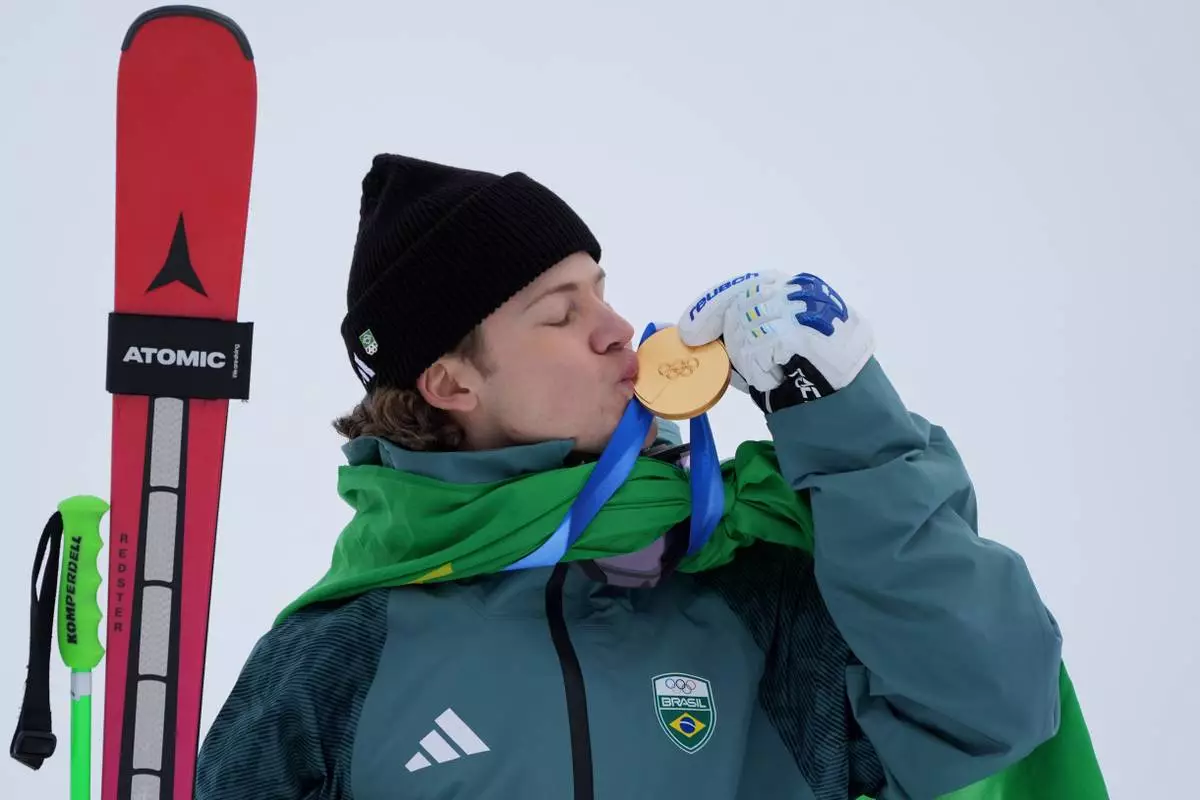 Brazil's Lucas Pinheiro Braathen kisses his gold medal for an alpine ski, men's giant slalom race, at the 2026 Winter Olympics, in Bormio, Italy, Saturday, Feb. 14, 2026. (AP Photo/Rebecca Blackwell)