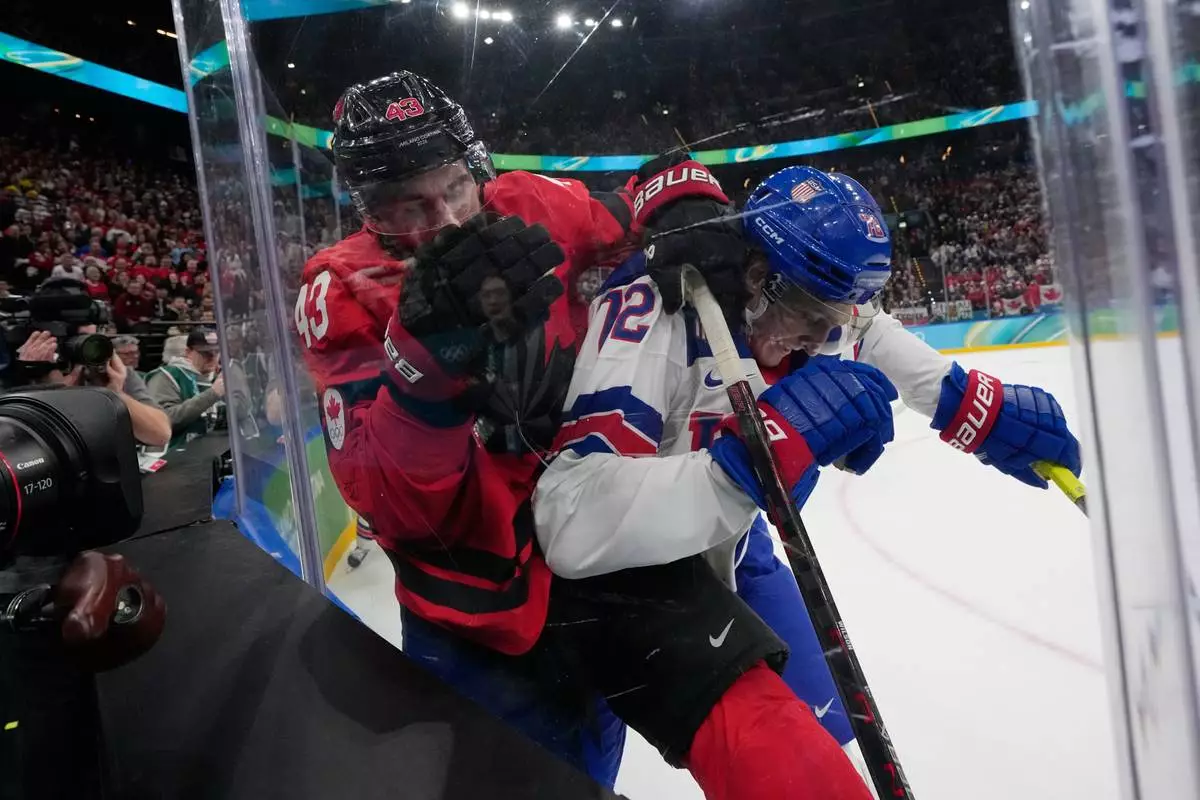 Canada's Tom Wilson (43) and United States' Tage Thompson (72) battle for the puck during the second period of a men's ice hockey gold medal game between Canada and the United States at the 2026 Winter Olympics, in Milan, Italy, Sunday, Feb. 22, 2026. (AP Photo/Petr David Josek)