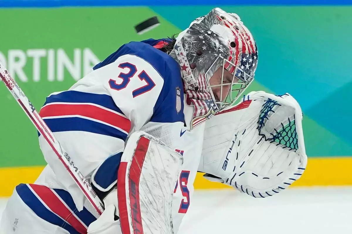 United States' Connor Hellebuyck (37) blocks a shot by Canada during a men's ice hockey gold medal game between Canada and the United States at the 2026 Winter Olympics, in Milan, Italy, Sunday, Feb. 22, 2026. (AP Photo/Petr David Josek)