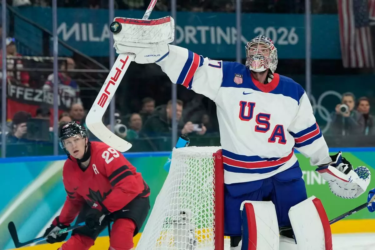 United States' Connor Hellebuyck (37) knocks the puck out of the air during the third period of a men's ice hockey gold medal game between Canada and the United States at the 2026 Winter Olympics, in Milan, Italy, Sunday, Feb. 22, 2026. (AP Photo/Petr David Josek)