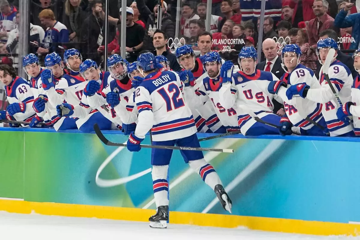 United States' Matt Boldy celebrates with teammates after scoring the opening goal during a men's ice hockey gold medal game between Canada and the United States at the 2026 Winter Olympics, in Milan, Italy, Sunday, Feb. 22, 2026. (AP Photo/Hassan Ammar)