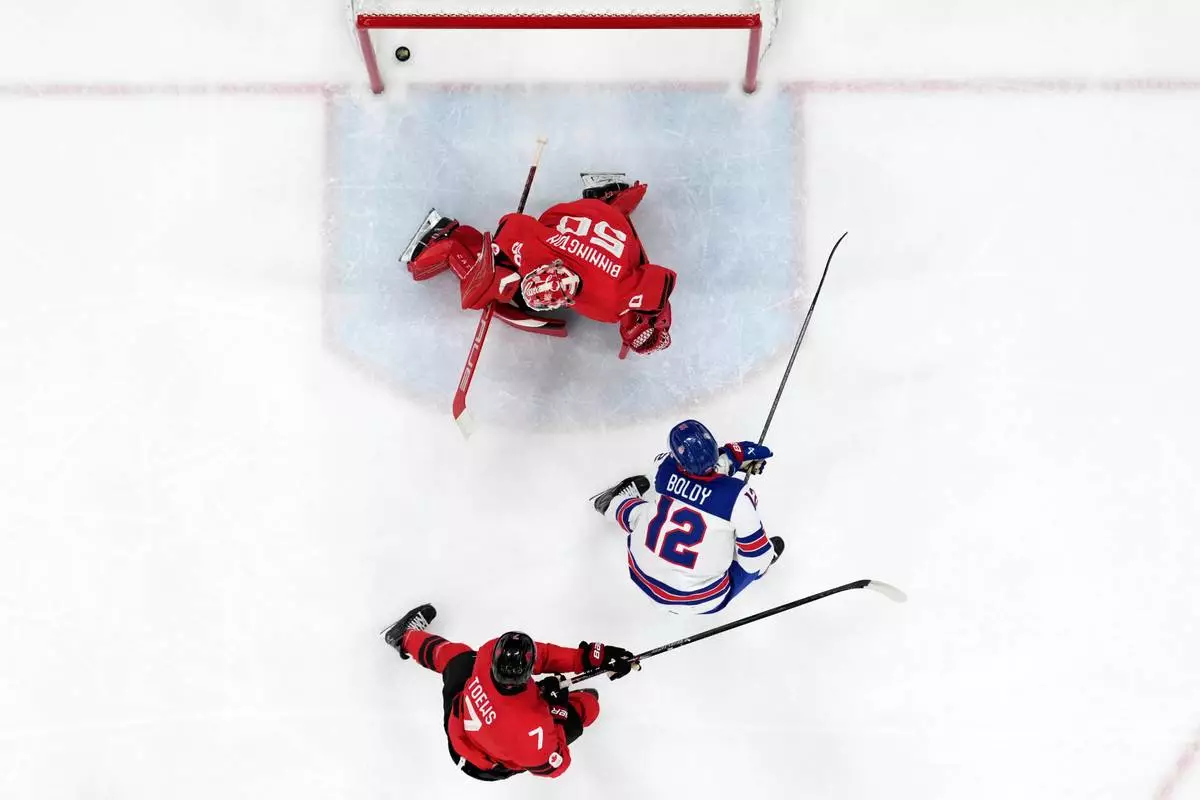 United States' Matt Boldy (12) scores his side's opening goal during a men's ice hockey gold medal game between Canada and the United States at the 2026 Winter Olympics, in Milan, Italy, Sunday, Feb. 22, 2026. (AP Photo/Nikos Seimenakis)