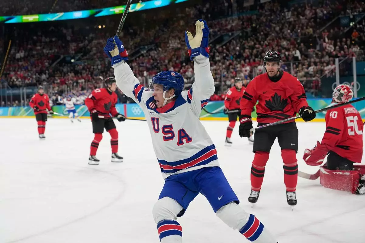 United States' Matt Boldy, center, celebrates after scoring the opening goal during a men's ice hockey gold medal game between Canada and the United States at the 2026 Winter Olympics, in Milan, Italy, Sunday, Feb. 22, 2026. (AP Photo/Hassan Ammar)